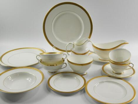 A Royal Doulton porcelain part dinner and tea service decorated in the Royal Gold pattern