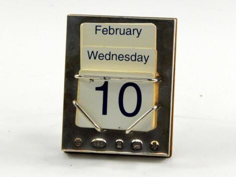 A silver backed perpetual calendar