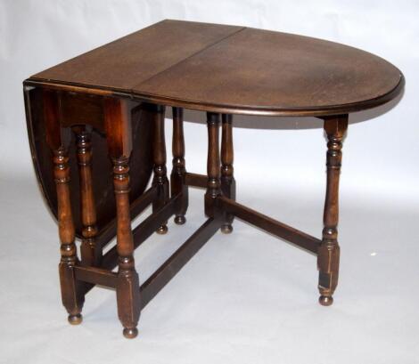 An oak gateleg dining table