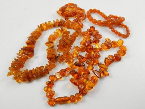 Four strings of amber or simulated amber beads