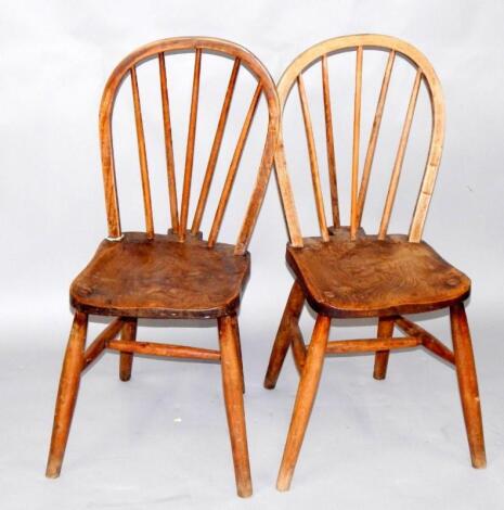 A pair of oak and elm spindle back kitchen chairs.