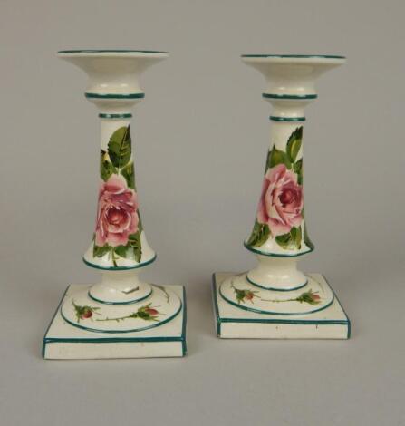 A pair of Wemyss pottery candlesticks
