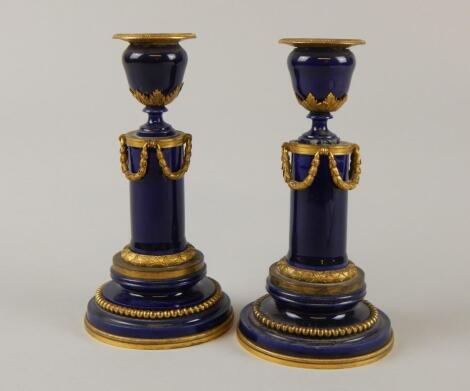 A pair of 19thC Continental porcelain candlesticks