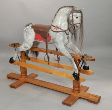 A modern dapple grey rocking horse