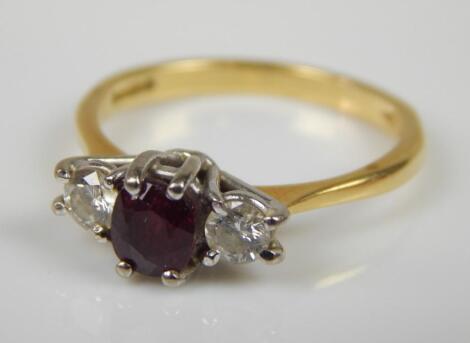 An 18ct gold ruby and diamond three stone ring