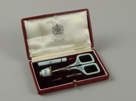 An Asprey silver and enamel sewing set