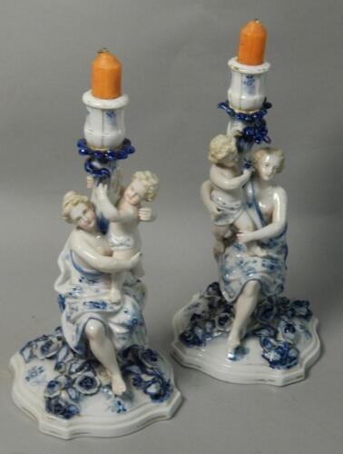 A pair of German Sitzendorf porcelain candlesticks