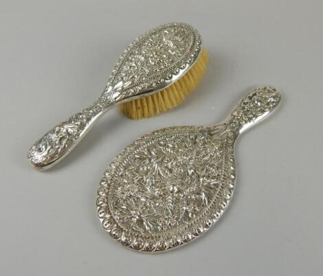 A sterling silver hand mirror and matching hairbrush