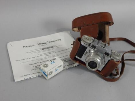 A Paxette chrome and pressed leather camera