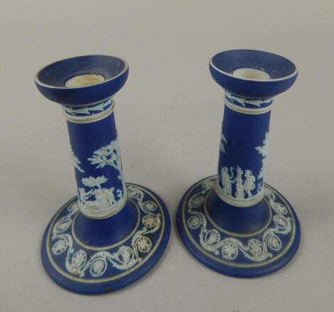 A pair of late 19thC dark blue Wedgwood Jasperware candlesticks