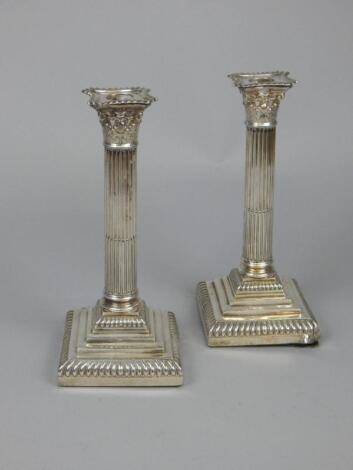 A pair of Edwardian silver Corinthian column candlesticks