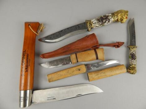 A collection of three daggers and an advertising sized pen knife