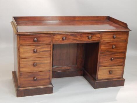 A Victorian figured mahogany kneehole desk