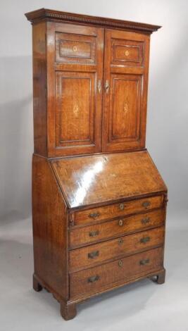 An early 19thC oak bureau bookcase