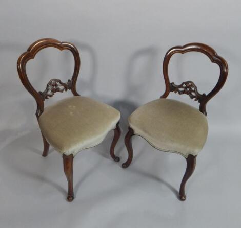 A pair of Victorian walnut balloon back chairs