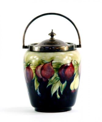 A Moorcroft Pottery biscuit barrel decorated in the Wisteria pattern