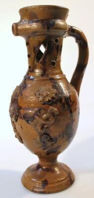 An 18thC English pottery puzzle jug