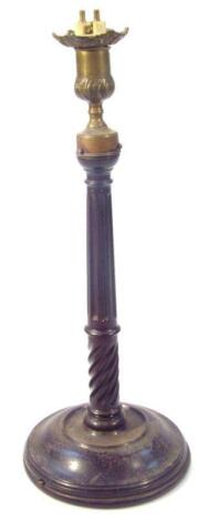 A 19thC mahogany and brass mounted candlestick