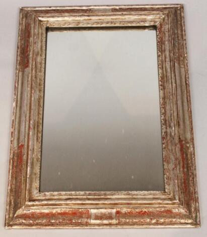 A heavily carved parcel gilt and red painted wooden frame