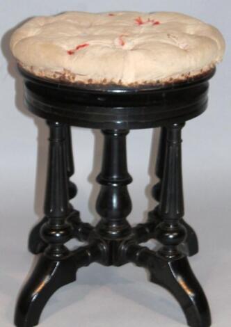 An Edwardian ebonised walnut piano stool