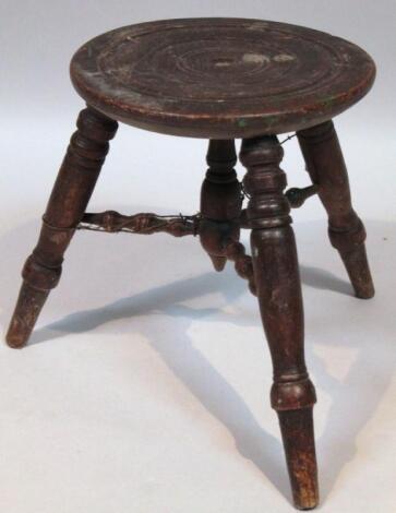 A 19thC elm and oak three pronged milking stool