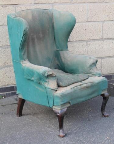 A 19thC walnut stained wingback armchair