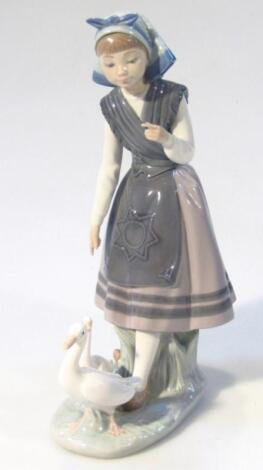 A 20thC Lladro figure of a girl aside geese