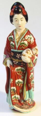 A 20thC semi porcelain figure of a geisha