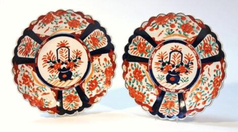 A pair of Japanese Imari pottery plates