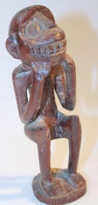 A heavily carved African tribal hardwood figure