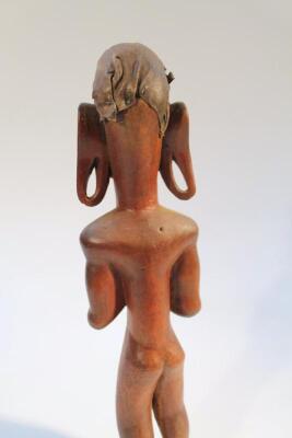 A heavily carved African figure - 3