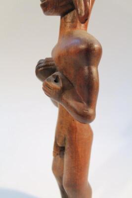 A heavily carved African figure - 4