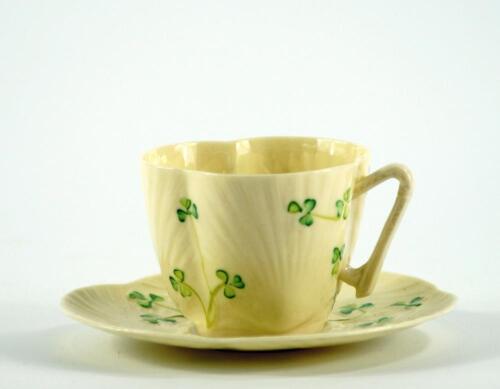 A Belleek shamrock shaped cup and saucer