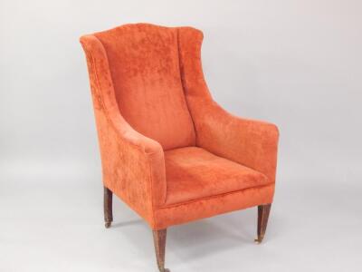 An Edwardian mahogany wingback armchair