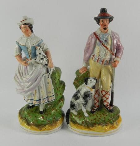 A pair of Staffordshire pottery flatback figures of a hunter and huntress