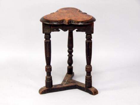 An Elizabethan style oak trefoil occasional table