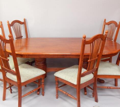 A Malaysian hardwood oval twin pedestal dining table