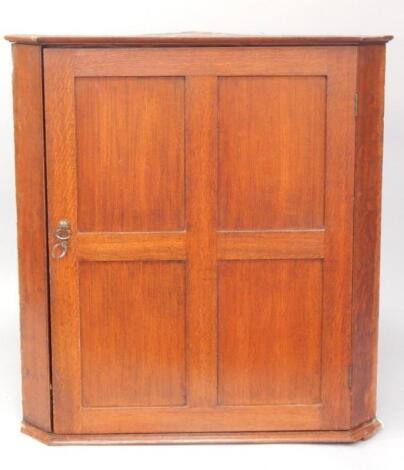 A George III oak provincial hanging corner cupboard