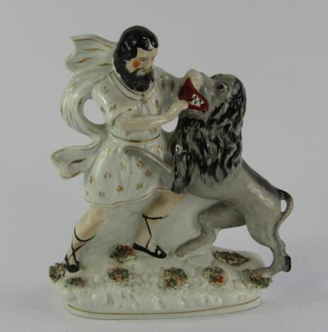 A Staffordshire pottery flatback figure group The Lion Tamer