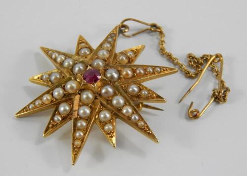 A Victorian yellow metal seed pearl and ruby brooch