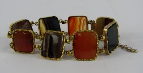 A yellow metal agate and hard stone bracelet