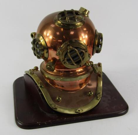 A replica brass and copper driver's helmet