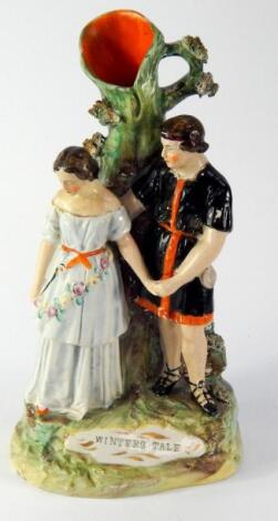 A Staffordshire pottery figural spill vase