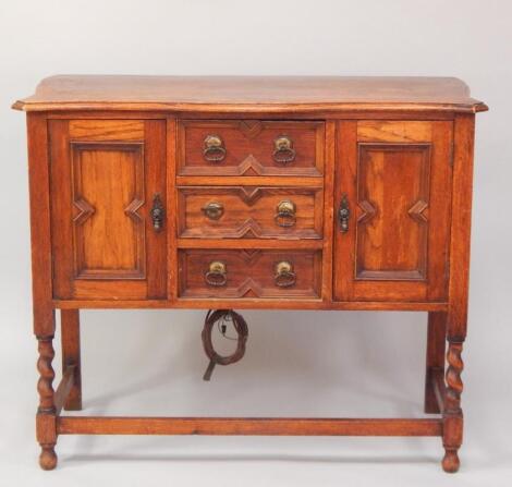 An oak serpentine sideboard