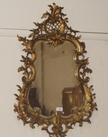 A rococo gilt wood wall mirror