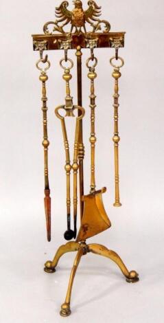 A brass tripod fireside companion set