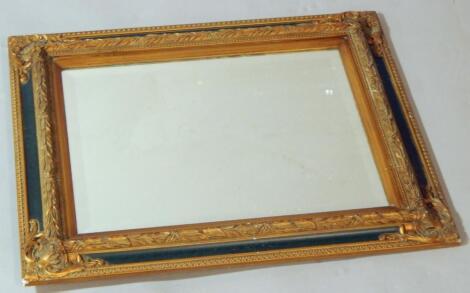 A green painted and giltwood wall mirror