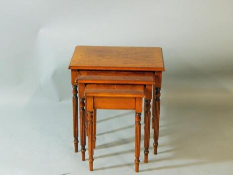 A nest of burr yew and oak cross banded occasional tables