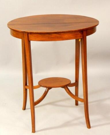 An Edwardian oval mahogany and line inlaid two tier occasional table