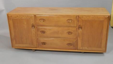 An Ercol light elm low sideboard